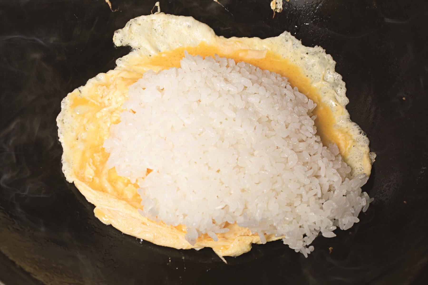 卵は完全に火を通さず、生の部分が残る状態でごはんを加える。
