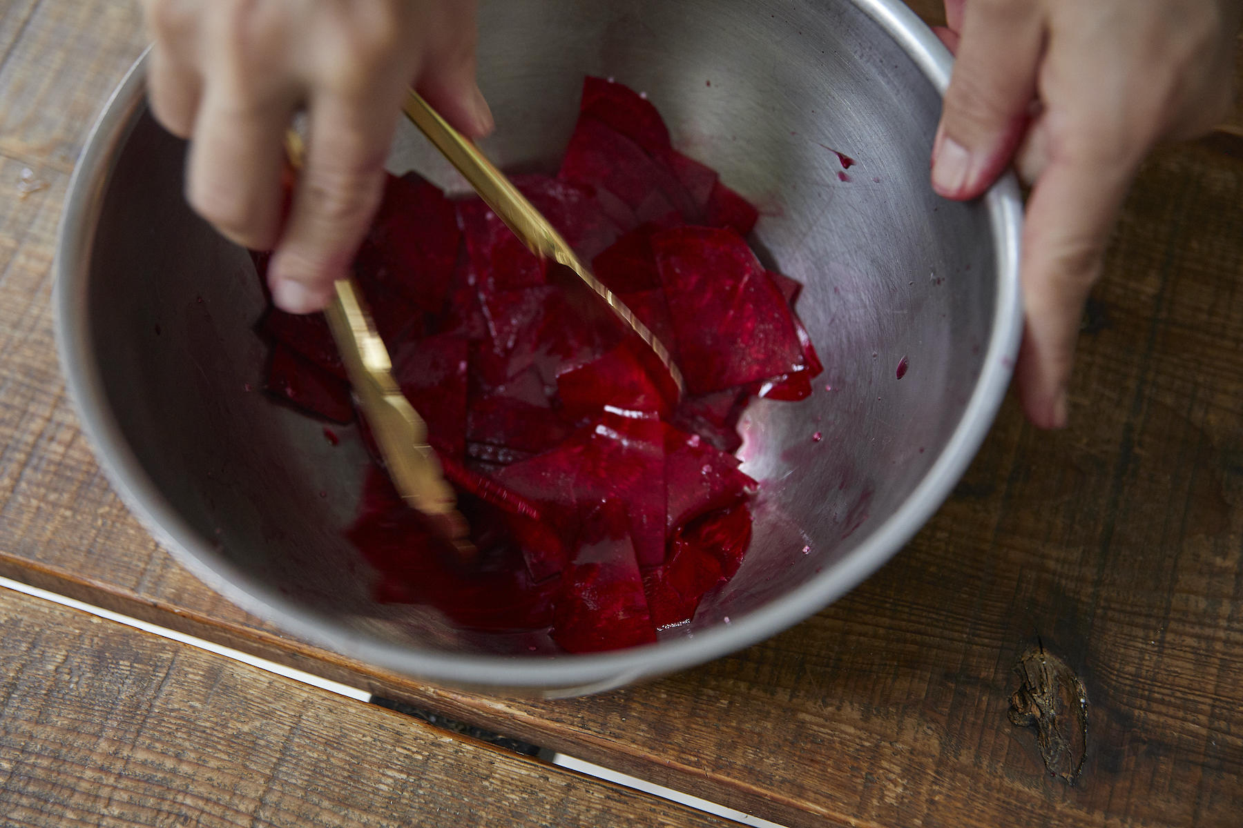 ボウルにビーツを入れ、赤ワインビネガーと塩ひとつまみを加えて混ぜ合わせる。