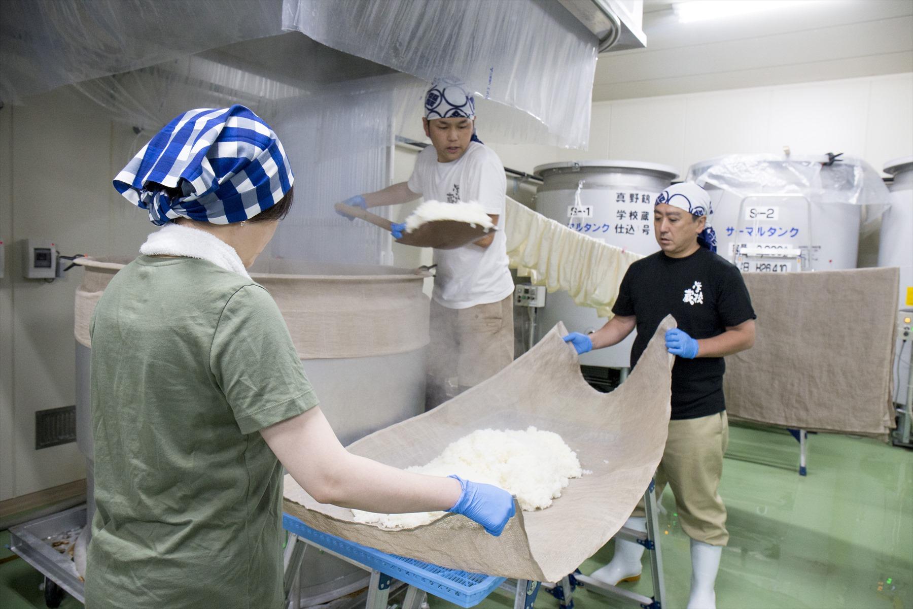 蒸し上がった米を受ける