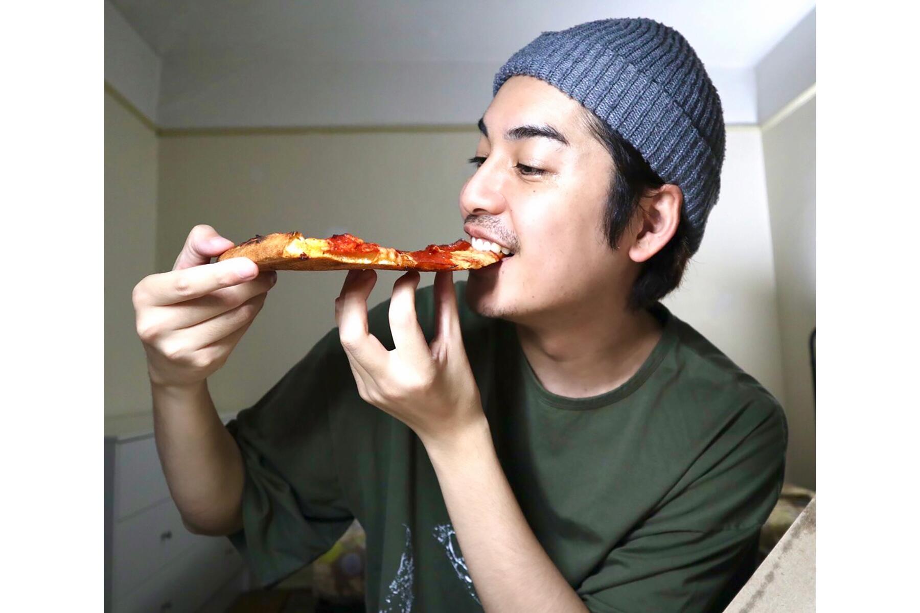 ピザにかぶりつく大野さん