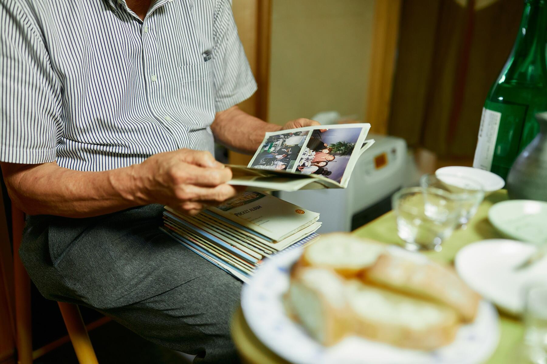 ミニアルバムの一冊を見る杉田さん