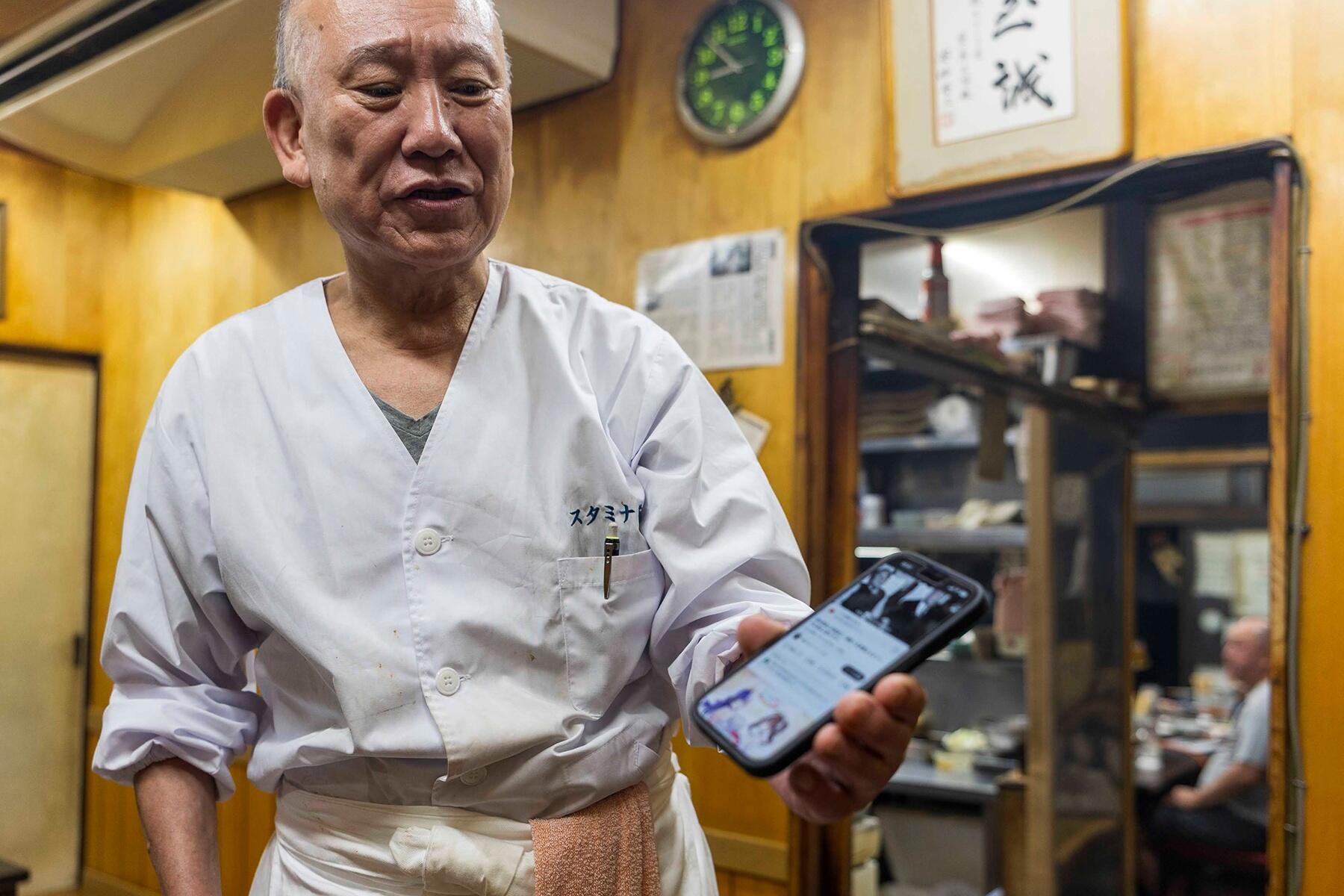 スマホを持つマコさん