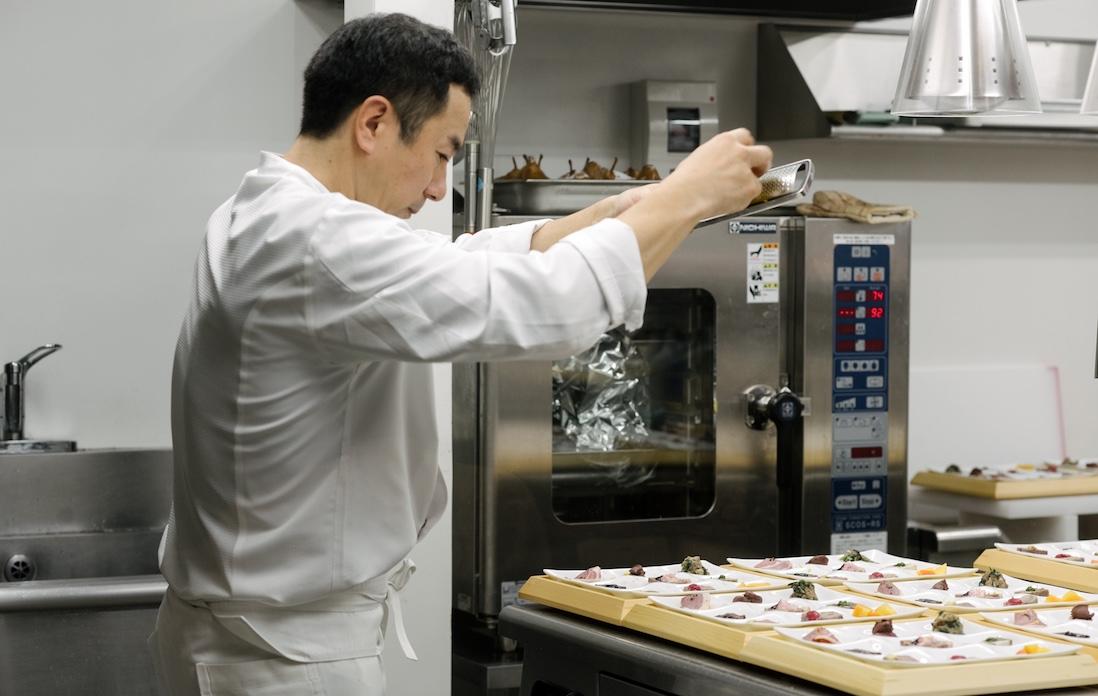 てきぱきと料理を仕上げていく有馬シェフ。自身のレストランは全12席。この日は約4倍に相当する40人近い客に腕を振るった。